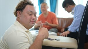 A father with grandchild plays games together in the living room to relax during the holidays